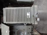 two old microwaves stacked on top of each other
