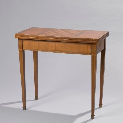 a small wooden table with a chess board on top of it