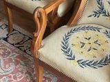 two chairs that are next to each other on a rug