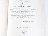 a book open to a page with a picture of mountains in the background