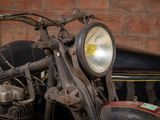 a motorcycle that is parked in front of a brick wall