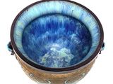 a blue bowl that is sitting on a white surface