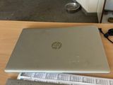 a laptop computer sitting on a table with papers and pencils