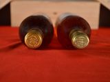 two bottles of wine that are sitting on a table