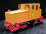 a yellow and red toy train on a black surface