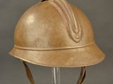 an old helmet on a stand on a gray background