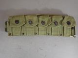 a green belt with buttons on it on a white surface