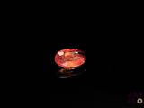 a red diamond in the dark on a black surface