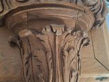 a close up of a wooden pillar with carvings on it