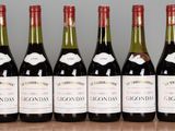six bottles of wine are lined up on a table