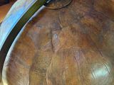 a large metal bowl with a handle on a wooden table