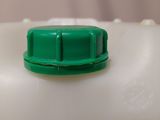 a plastic container with a green cap on top of it