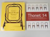 deux livres posés sur une table, avec une chaise et une jaquette