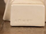 a close up of a white ceramic object on the floor