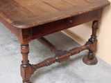 a small wooden table with a drawer on it