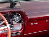 a red car dashboard with a steering wheel and a dash board