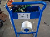 a blue cart with a roll of toilet paper in it
