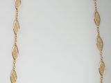 a gold necklace on a white background