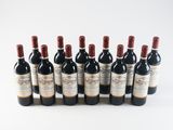 six bottles of red wine lined up in a row on a white surface