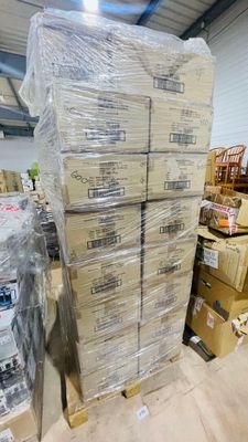 a large stack of boxes sitting on the floor in a warehouse