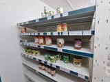 many shelves in the store that have canned food on them