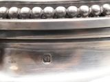 a close up of a silver plate with beads on it
