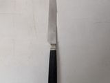 a knife that is laying on a table