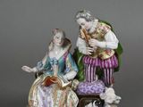 figurine of a man and a woman with a dog and a cat
