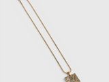 a gold necklace with a square pendant on a chain