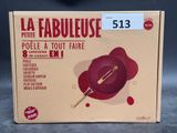 packaging of a red bowl with a wooden spoon on top of it