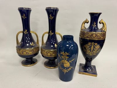 trois vases bleus ornés de motifs dorés, posés sur une surface blanche
