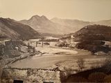 an old photo of a view of a bridge over a river