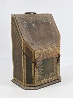 an old brown box with a metal handle on a white background
