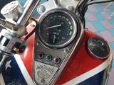 a red, white and blue motorcycle with a speedometer on it