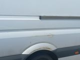 a white van that is parked on the side of the road