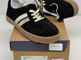 pair of black and white sneakers on top of a cardboard box