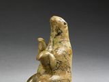 an image of a statue of a bear sitting on its back