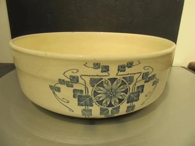 a white bowl with blue designs on it sitting on a table