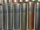 a lot of books that are sitting on a shelf