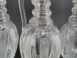 three clear glass vases sitting next to each other on a table