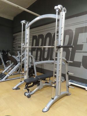 a row of exercise equipment in a gym room
