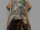 statue of a dog laying down on its back on a gray surface