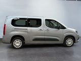 the silver van is parked in the garage of a building