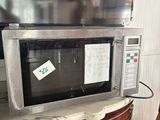 a microwave that is sitting on top of a cabinet