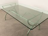 a glass table with metal legs and a glass top