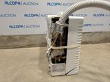 an air conditioner sitting on the floor in front of a wall