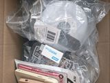 a cardboard box filled with electronic devices and other items