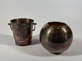 two vases sitting next to each other on a white surface