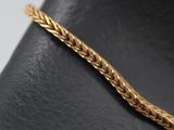 a close up of a gold bracelet on a mannequin mannequin mannequin mannequin mannequin mannequin mannequin manne