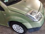 a small green car that is parked in a garage